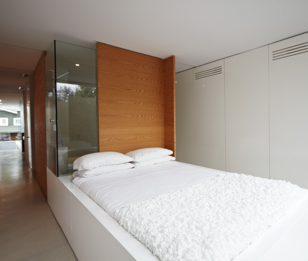 Custom vanity, shower/bath and bed designed to appear as a single unit.