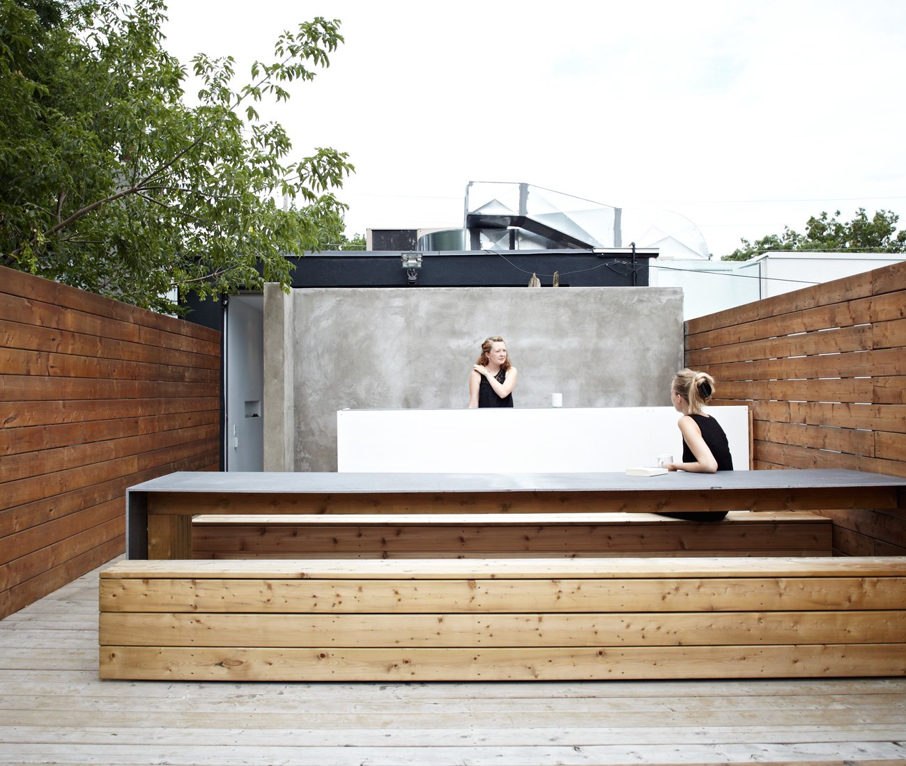Johnson Chou Interior design - Rooftop patio features a bar clad in white acrylic and stainless steel