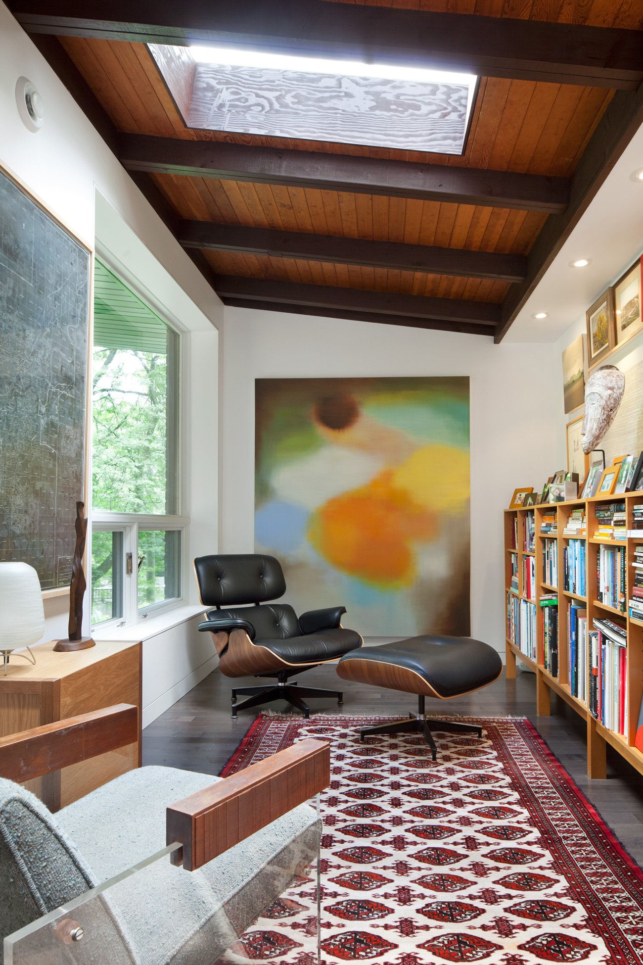 mid century modern furniture in a room lit by a new skylight.