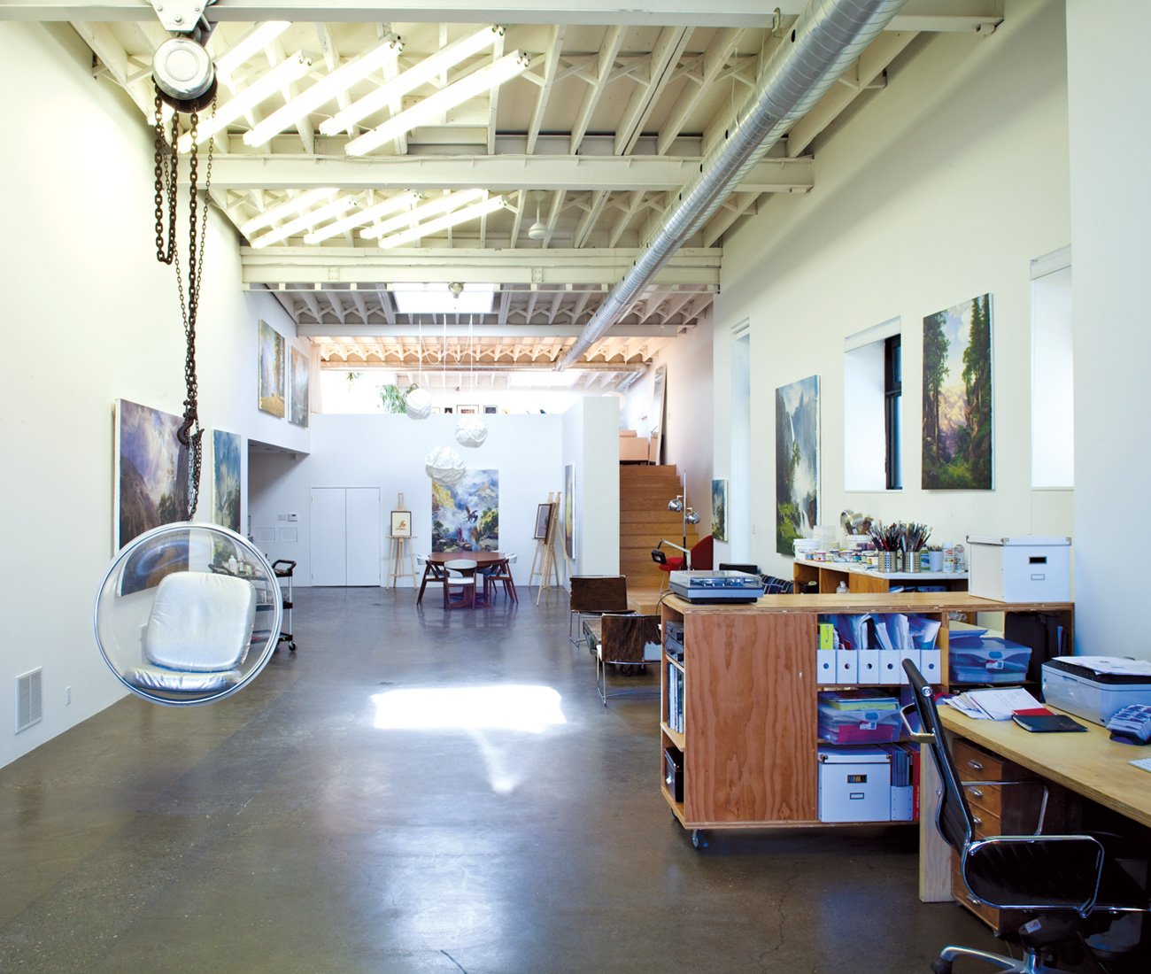 kent monkman studio with some of his art visible on the walls