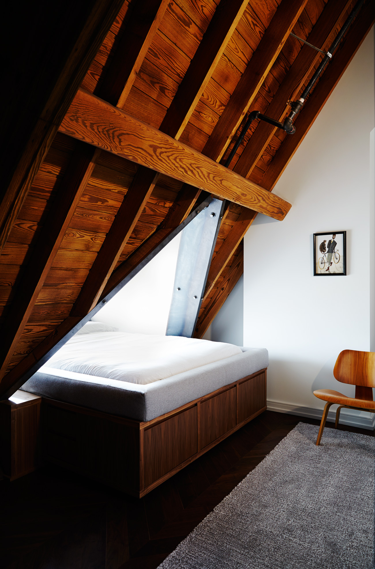 Walnut-veneer storage bed fits snugly under the steel-reinforced dormer at the converted Neo gothic church condo by Alison Milne