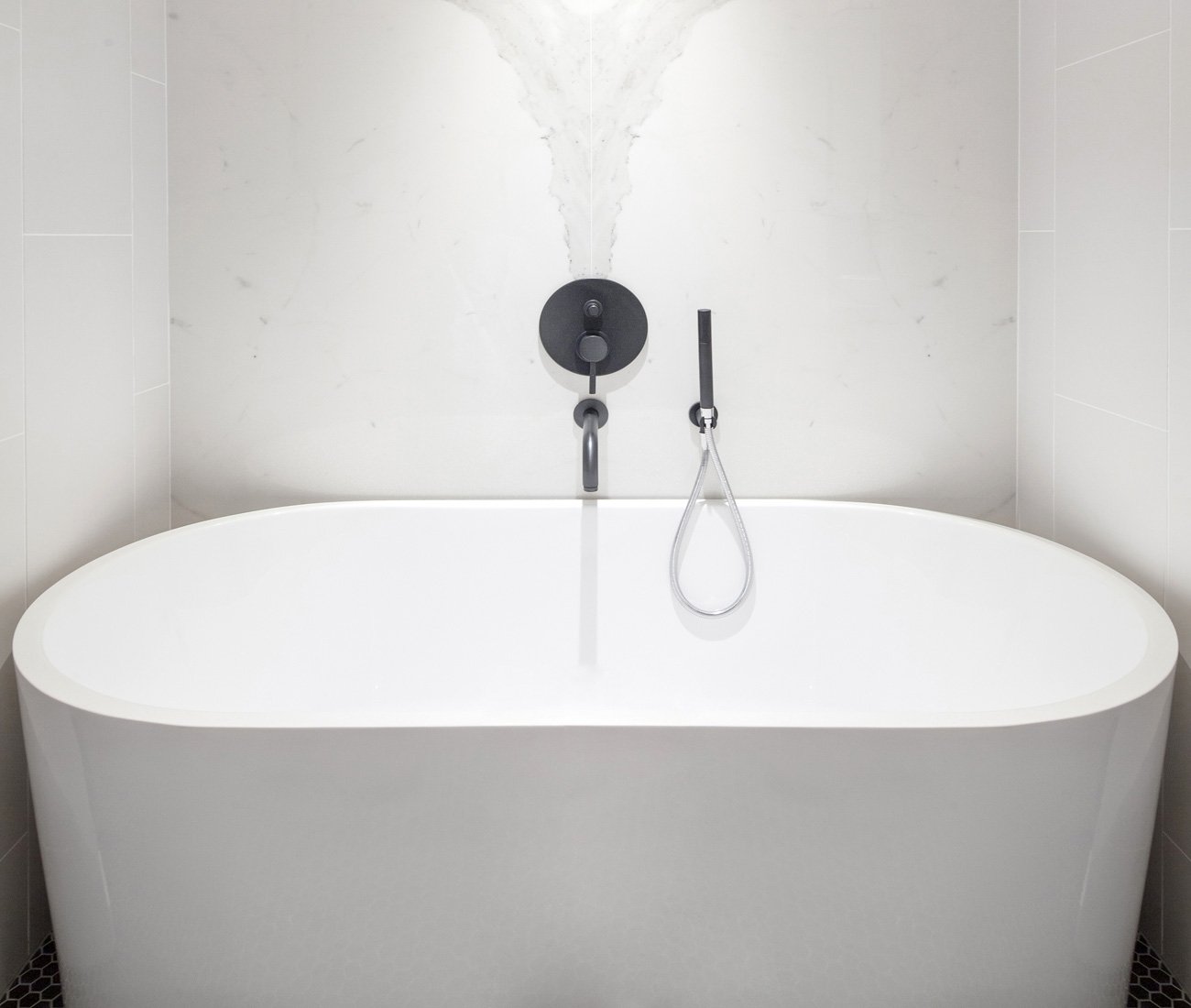 freestanding tub and hex-mosaic floor tiling