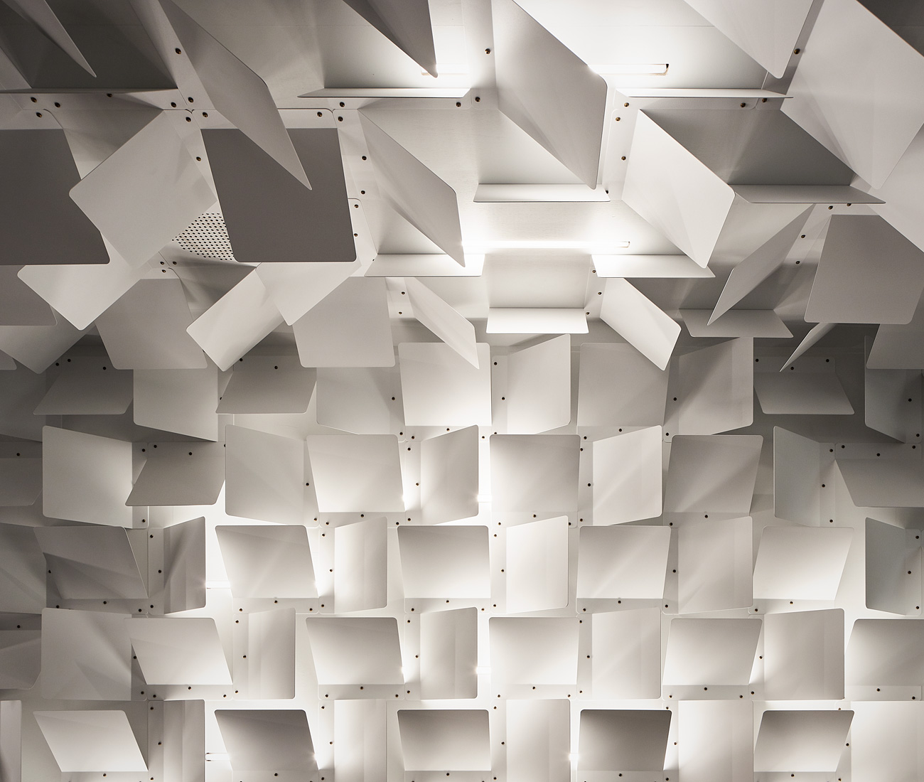 powder-coated folded metal panels that wrap around the walls and ceiling