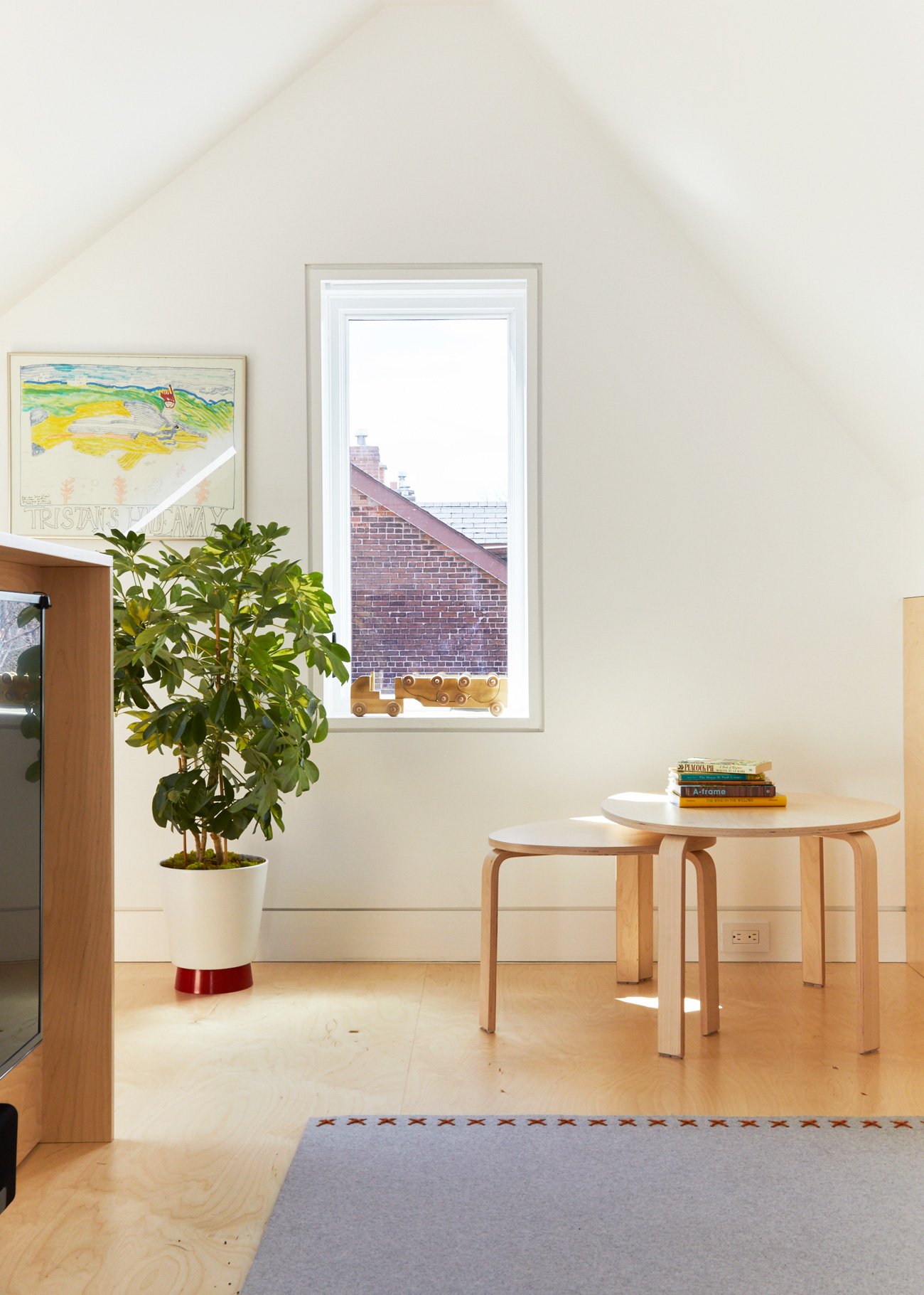 Attic Remodel Toronto Boychuk Fuller Parkdale Modern Home Newly replaced windows by Boychuk Fuller with a family TV blending seamlessly into custom millwork.