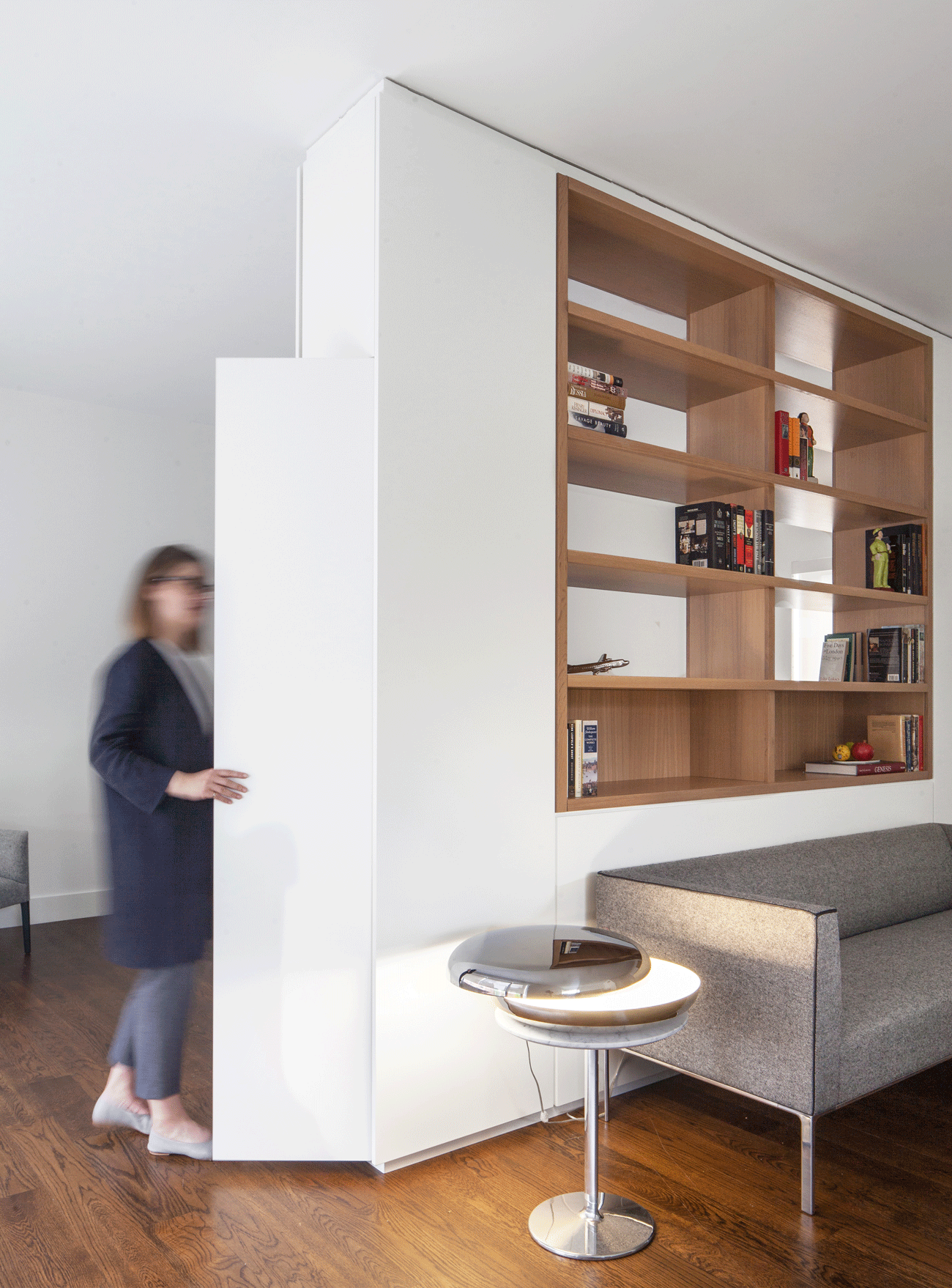 Closet built into the bookshelf, interiors details of a coach house in Toronto by architect Barbora Vokac Taylor