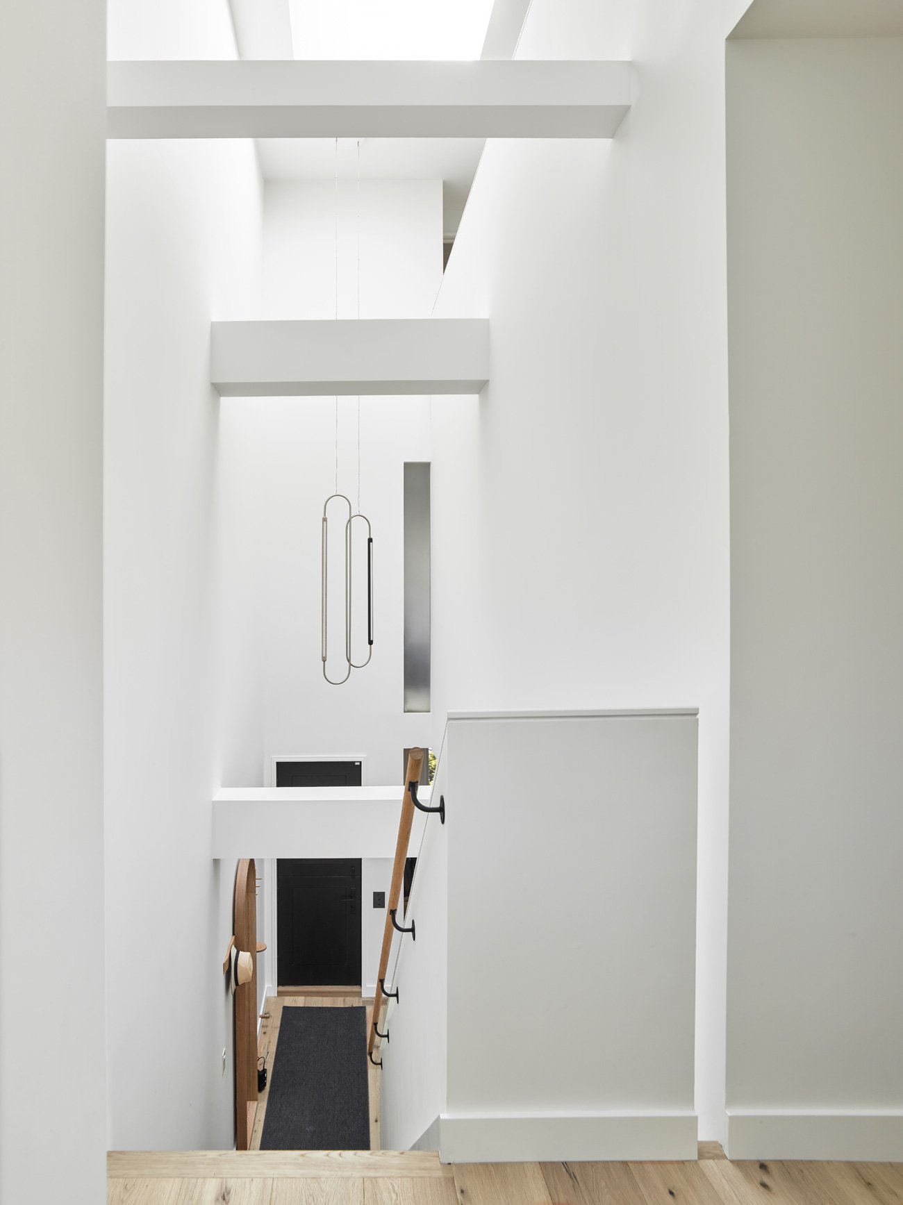 House interior with stairs and pendants from ceiling