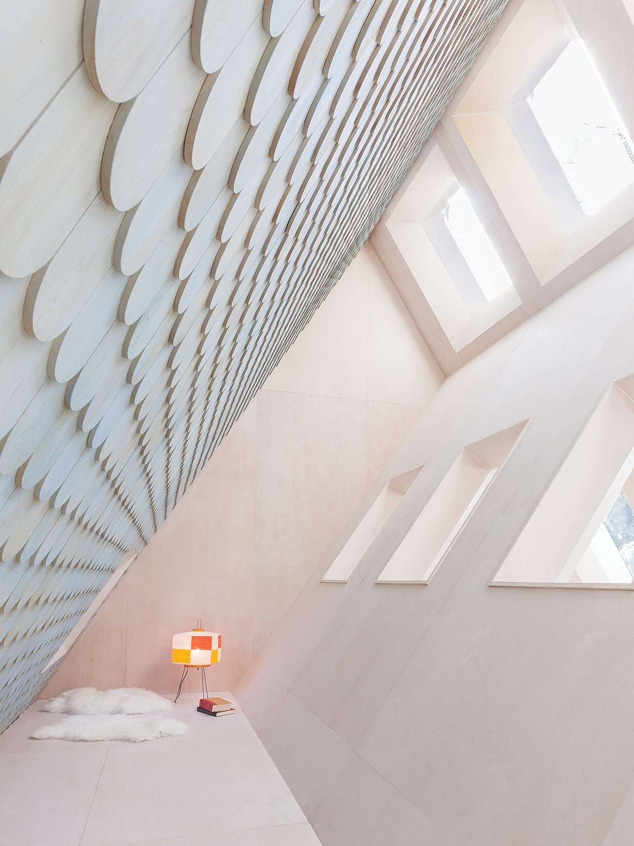 Modern cottage with a pitched roofline and the top portion becomes a narrow sleeping loft