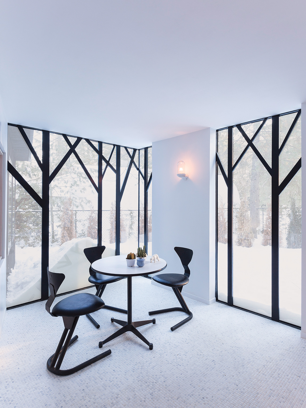 Black steel window frames shaped like trees