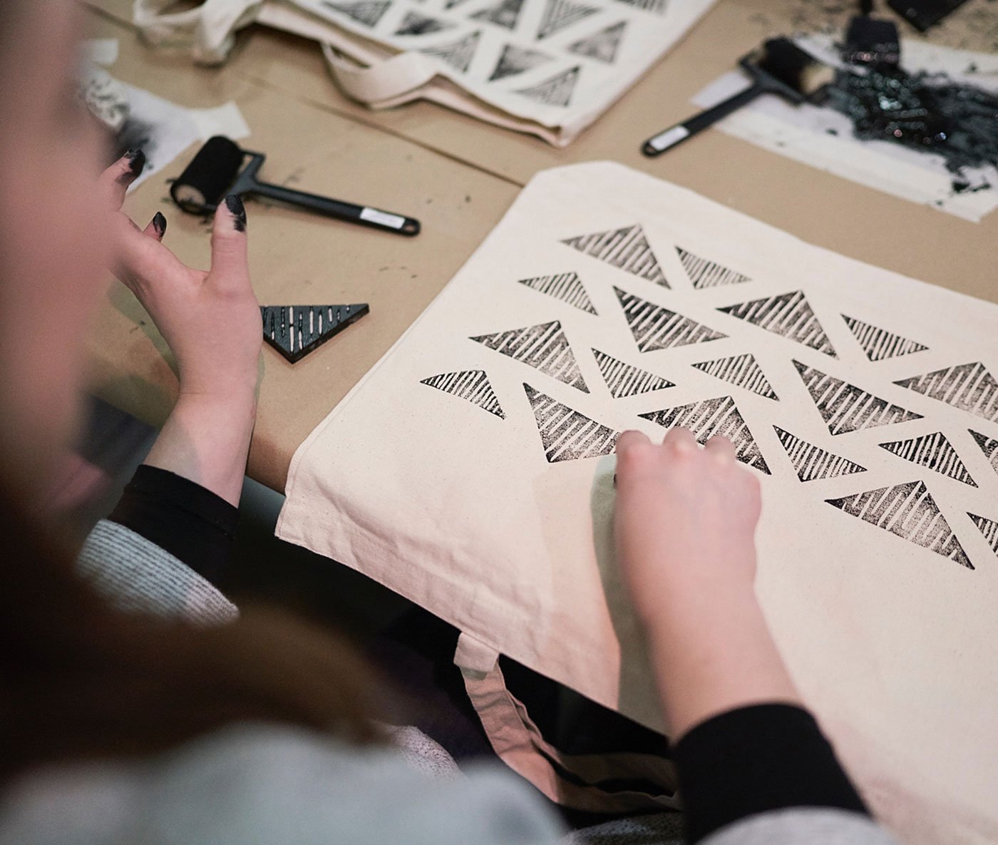 An artisan is Printing on a bagOne of a Kind Winter Show 2018