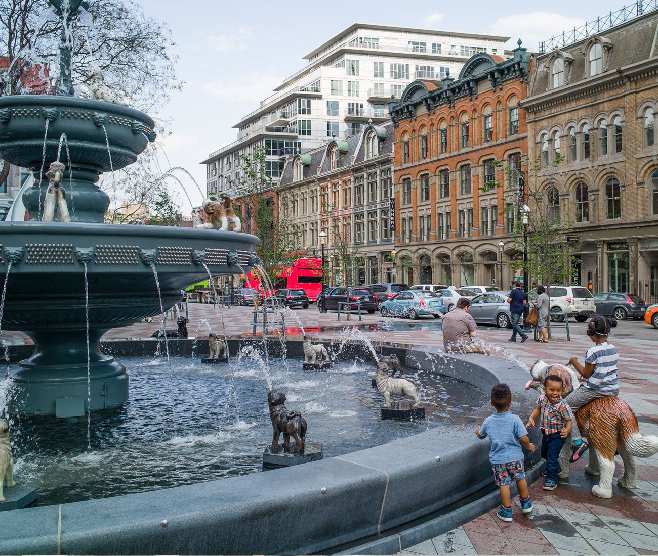 People around the dog fountain at Berczy Park in Toronto