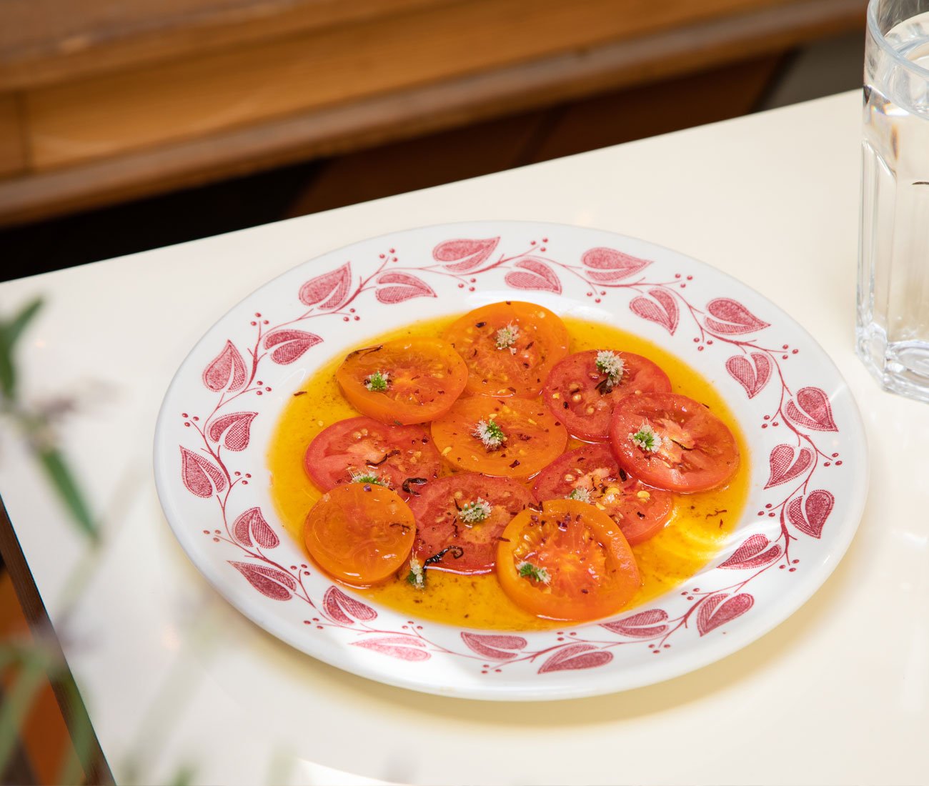 Plate with sliced tomatoes with oil of olive - Jen Agg