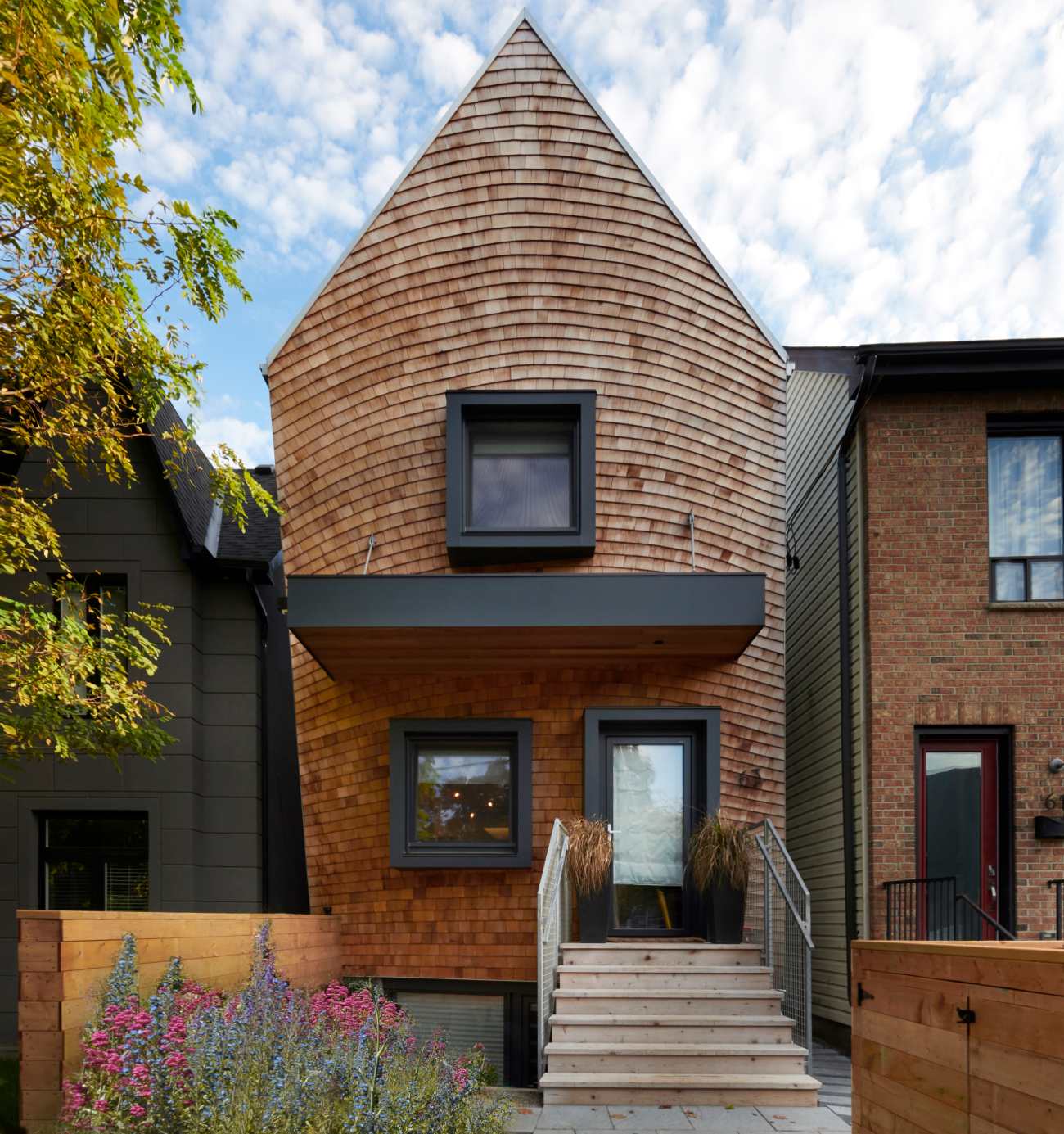 Curved Facade Home with cedar shingles by Craig Race Architecture