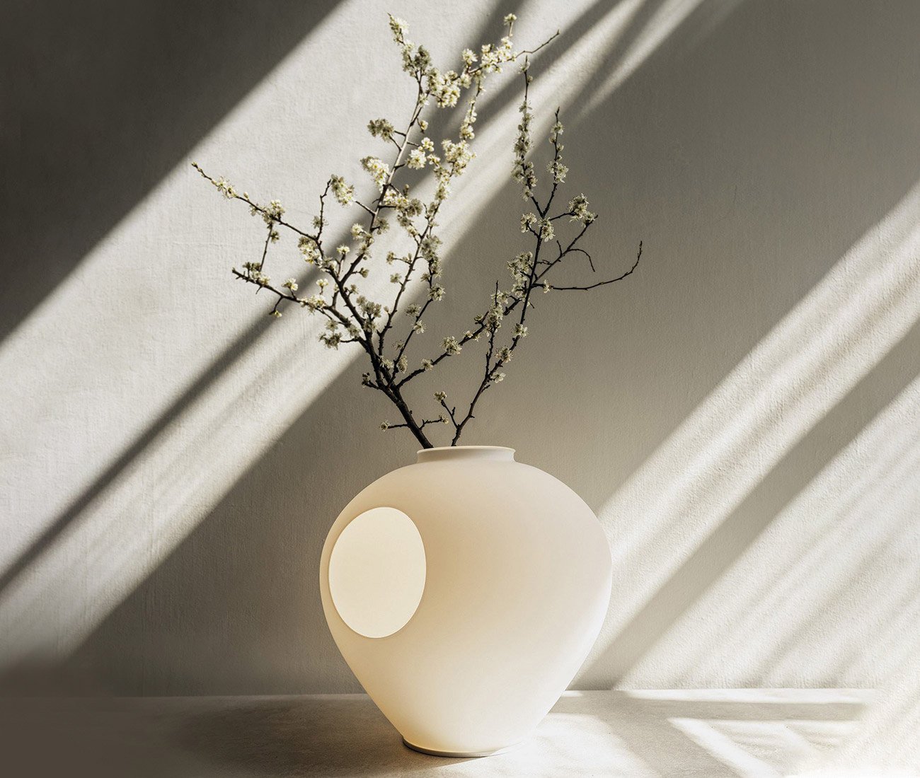 Table lamp, with branch of flowers behind it - Lightform new website shop