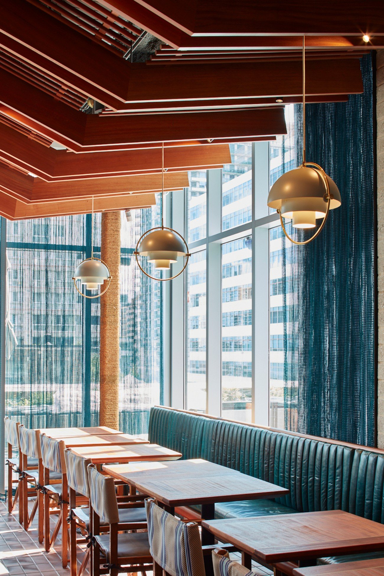 Restaurant tables with pendants lights at Stock TC in Toronto