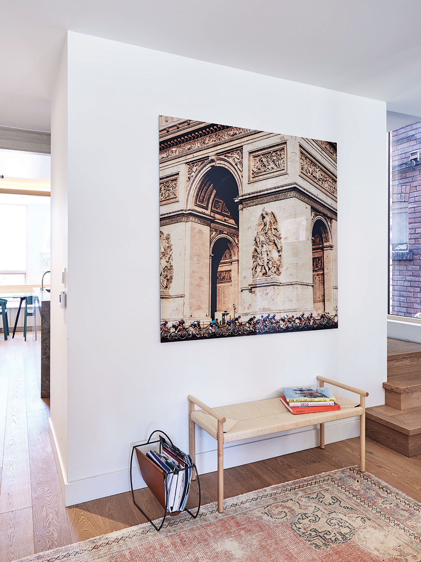 An enlarged photograph by Jared Gruber hangs between the new white oak landing and the kitchen to the left 