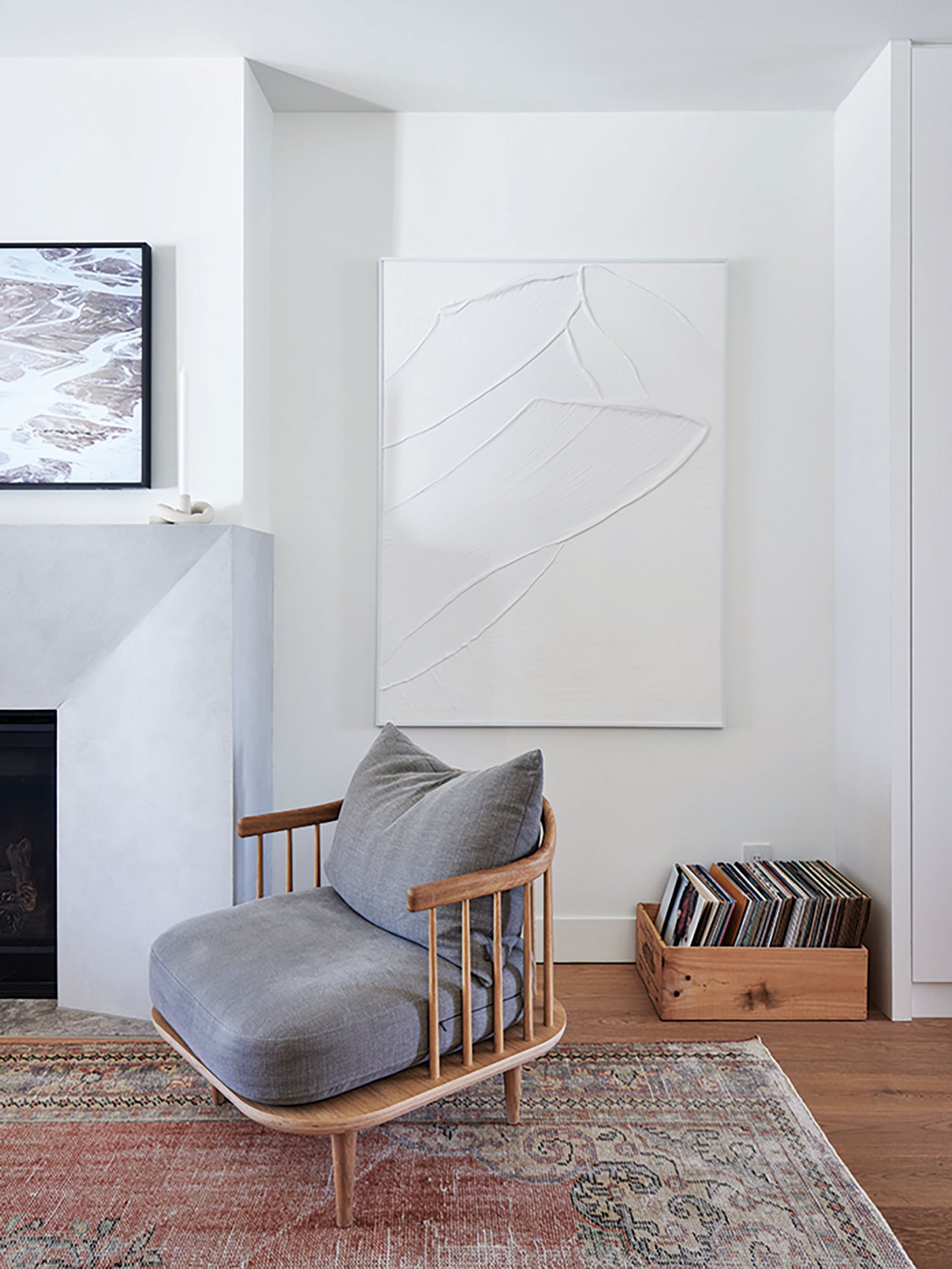 The sculptural fireplace is clad in trowelled microcement. A leftover piece of the kitchen island serves as the base. Artwork, Kenshin Art Gallery