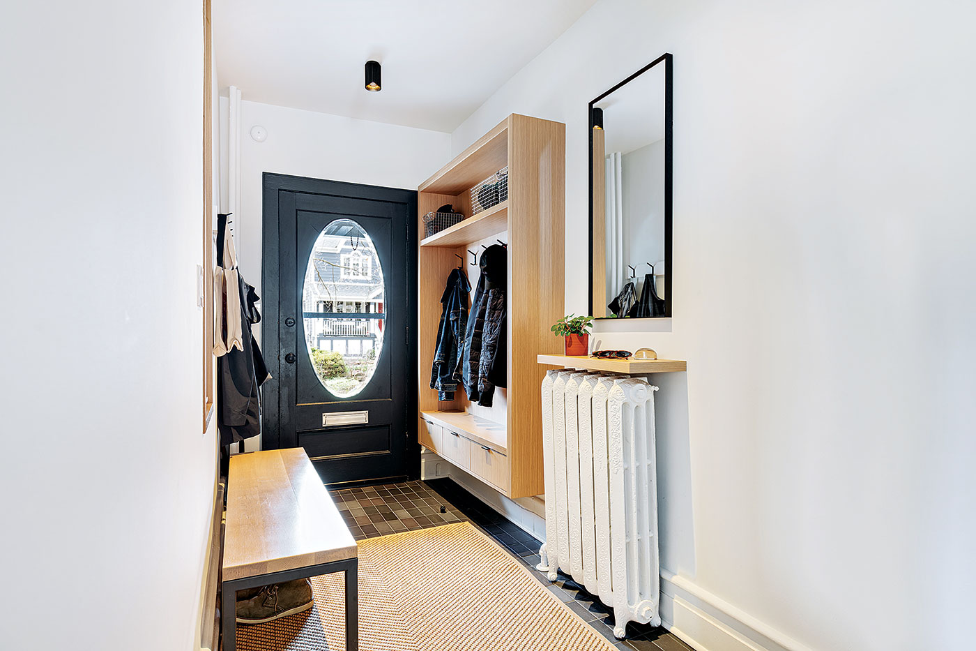 Framing the foyer’s coat hooks with millwork, Architect Heather Asquith Beach semi