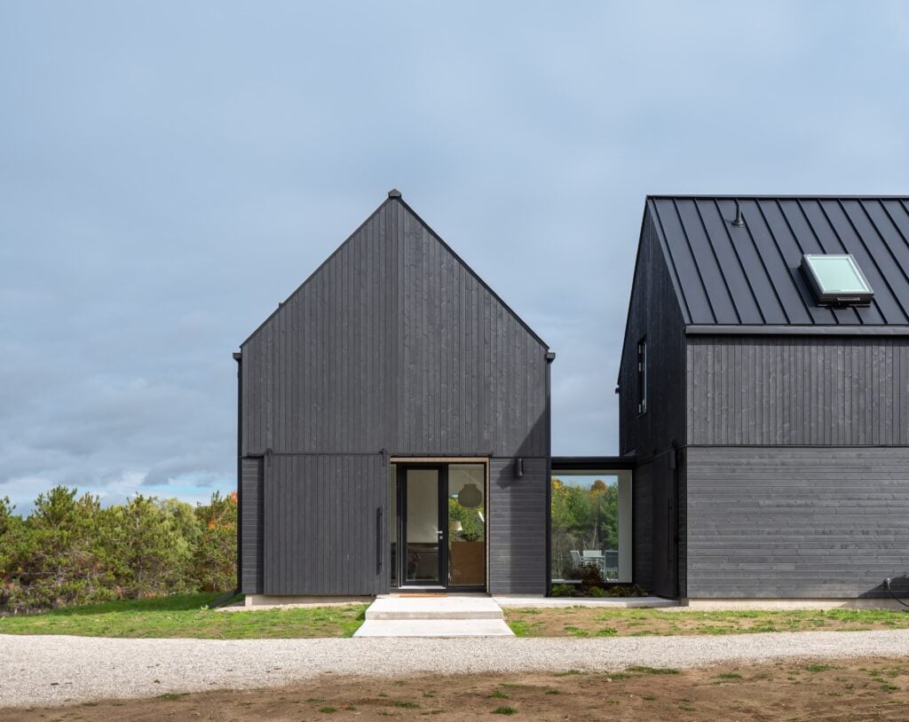 front door made of aluminum-clad wood is paired with a barn door