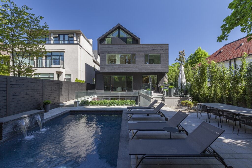 backyard view with a pool RZLBD Stacked House
